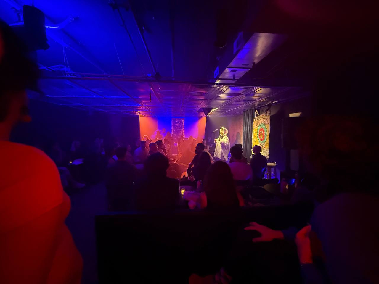 Comedian performing at SESH Comedy